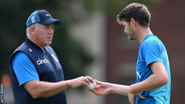 England head coach Chris Silverwood (left) talks to bowler David Payne (right)