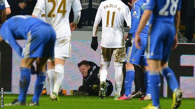 Swansea ball boy Charlie Morgan, apparently "fell on top of the ball"