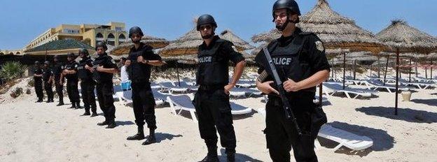 Members of the Tunisian security services stand guard during a memorial ceremony