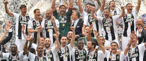 Juventus players holding the trophy after winning their seventh league titles in a row