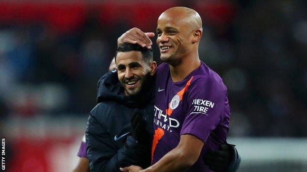 Vincent Kompany pictured with Manchester City teammate Riyad Mahrez