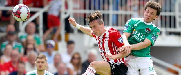 Derry midfielder Aaron McEneff gets in front of Cork's Barry McNamee in a battle for the high ball