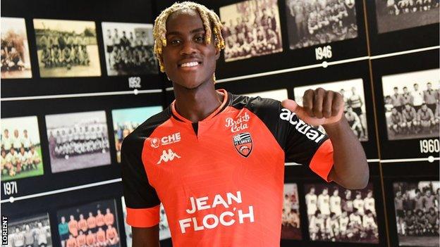 Trevoh Chalobah poses with his new Lorient shirt