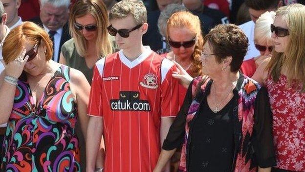 Suzie Evans (l) and Owen Richards joined the crowds at Walsall FC to remember their three family members Adrian Evans, Pat Evans and Joel Richards