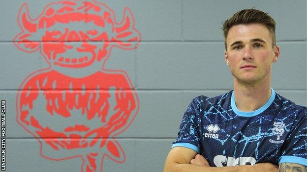 Jamie Robson poses in a Lincoln shirt