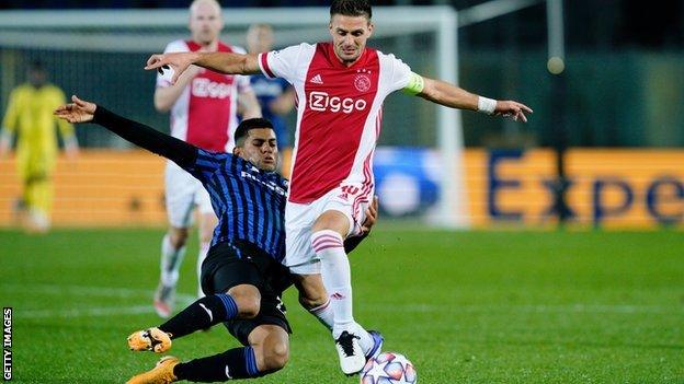 Remo Freuler tackles Ajax's Dusan Tadic in a Champions League game