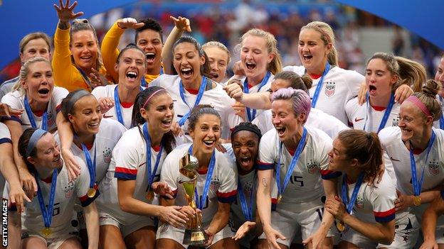 The US women's football team prepare to lift the 2019 World Cup on the podium