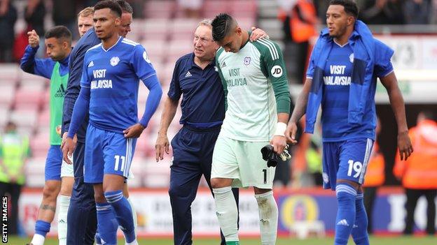 Cardiff boss Neil Warnock hugging goalkeeper Neil Etheridge as they walk off the pitch together