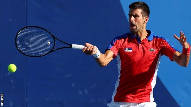 Novak Djokovic returns a ball in his third-round match at the Tokyo Olympics