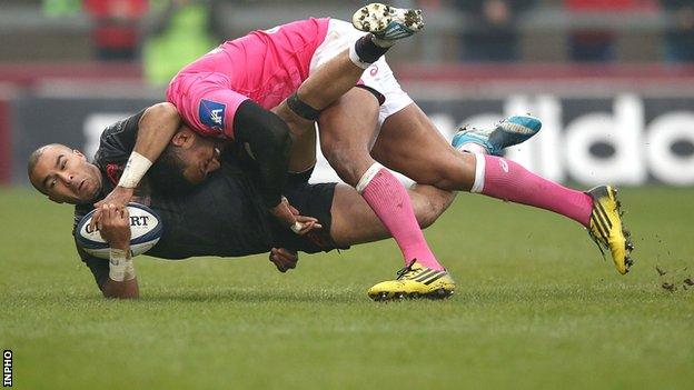 Munster's Simon Zebo is tackled by Stade Francais's Julien Arias at Thomond Park