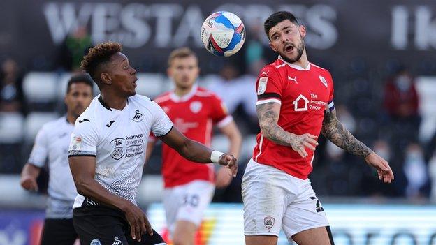 Barnsley's Alex Mowatt battles with Swansea's Jamal Lowe