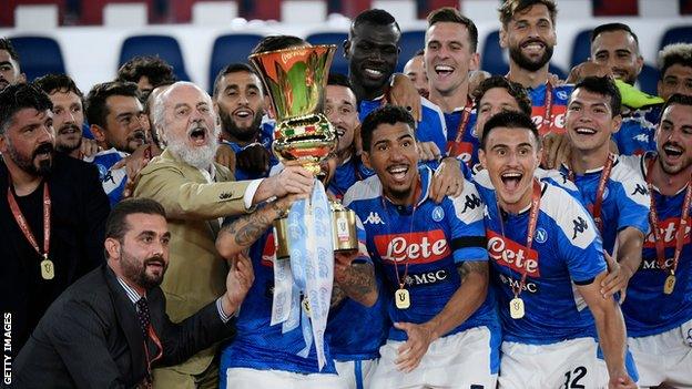 Napoli president and owner Aurelio de Laurentiis celebrates with his players after winning the Coppa Italia