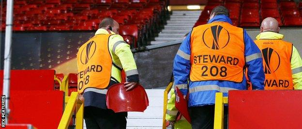 A broken seat is held by a steward