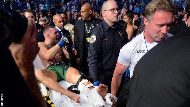 Conor McGregor leaves the octagon on a stretcher