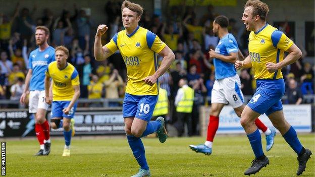 Armani Little celebrates scoring a goal for Torquay United