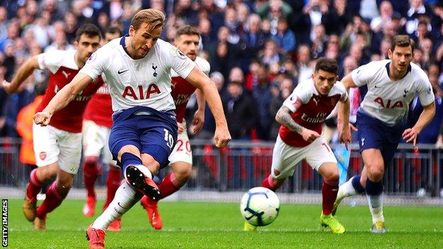 Tottenham striker Harry Kane scores a penalty against Arsenal