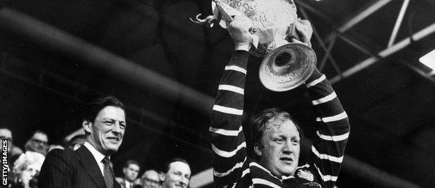Malcolm Dixon, a miner, lifts the Challenge Cup aloft for Featherstone