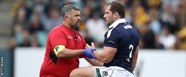 Fraser Brown receives medical attention while playing for Scotland