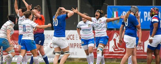 Italy players celebrate, French players with their heads in their hands