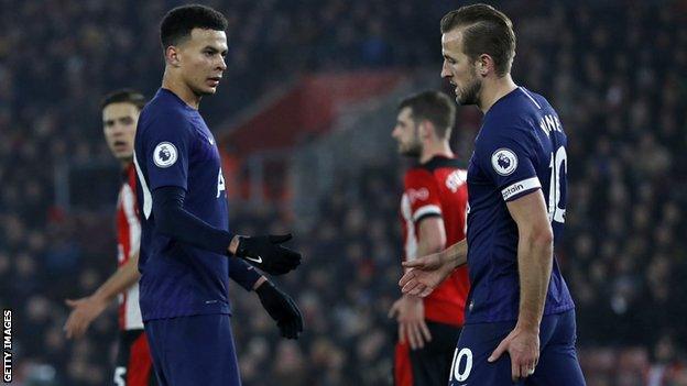 Tottenham striker Harry Kane (right) holds his hamstring as he walks off injured against Southampton