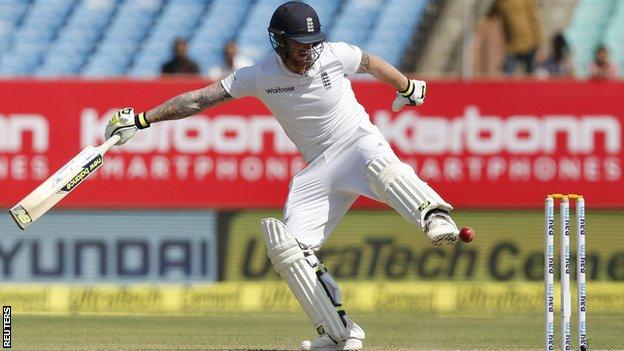 England's Ben Stokes attempts to kick the ball away from his stumps