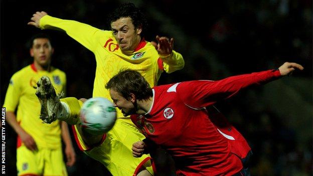 Wales captain Simon Davies clears the ball from Norway striker Erik Nevland during the International Friendly Match at The Racecourse Ground on February 6, 2008 in Wrexham