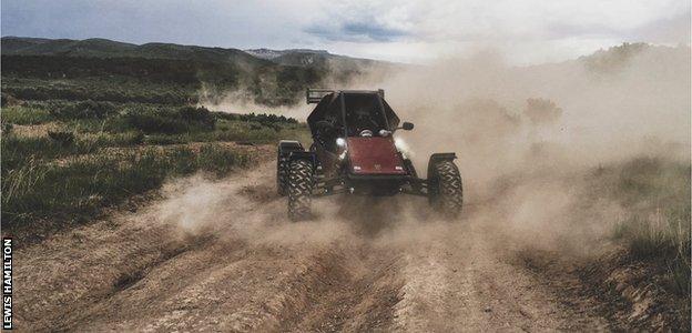 Lewis Hamilton riding a dune buggy