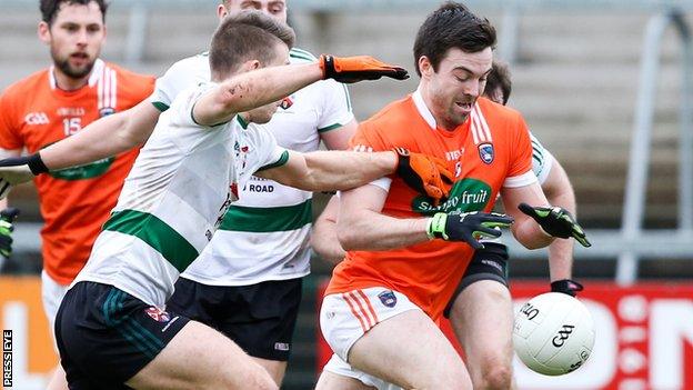 Shea Heffron of Queen's challenges Armagh's Aidan Forker at the Athletic Grounds