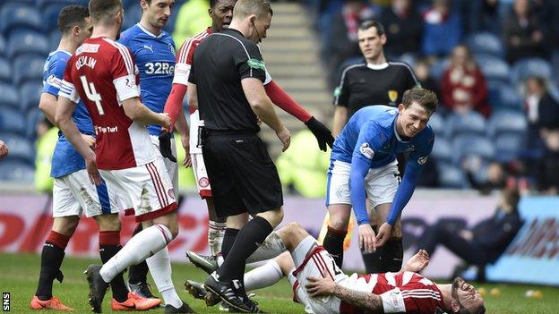 Referee John Beaton yellow carded Rangers striker Joe Garner for a wild challenge on Hamilton's Dougie Imrie