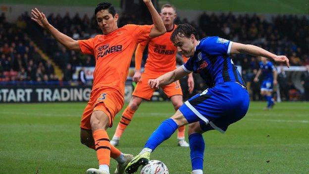 Newcastle's Yoshinori Muto and Oliver Rathbone of Rochdale battle for possession