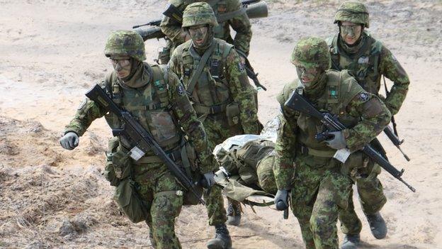 Estonian soldiers performing an exercise during war games.