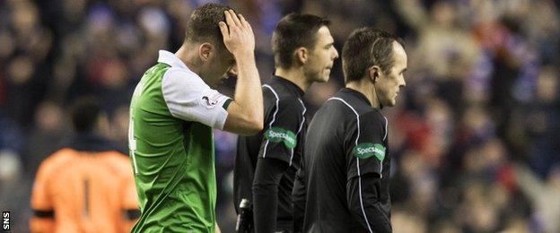 Paul Hanlon cuts a dejected figure after losing to Rangers