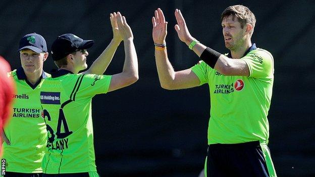 Boyd Rankin (right) is congratulated after taking one of three Scottish wickets