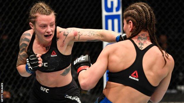 Joanne Calderwood punches Jessica Eye during her win at UFC 257