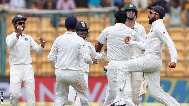 India celebrate the wicket of Mitchell Marsh