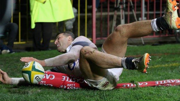 Jonny May flattens a flag as he scores England's try on Saturday