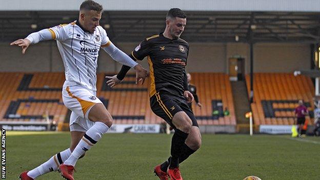 Kyle Howkins (L) challenges Newport striker Padraig Amond while on loan at Port Vale