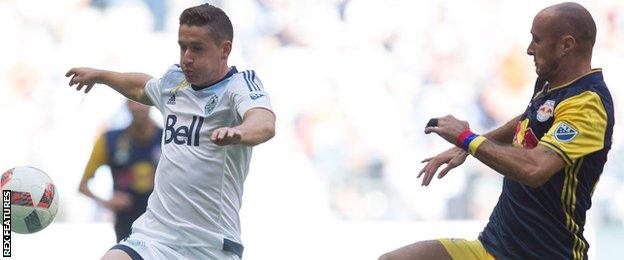 Fraser Aird in action for Vancouver Whitecaps against New York Red Bulls' Aurelien Collin