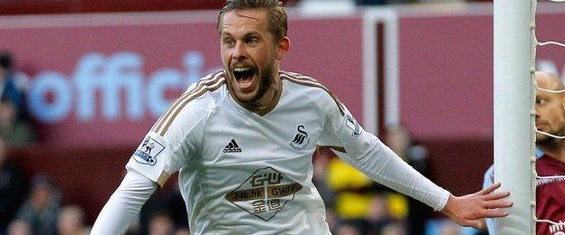 Gylfi Sigurdsson of Swansea City celebrates his team's second goal by Andre Ayew (obscured) during the Barclays Premier League match between Aston Villa and Swansea City at Villa Park on October 24, 2015 in Birmingham, England