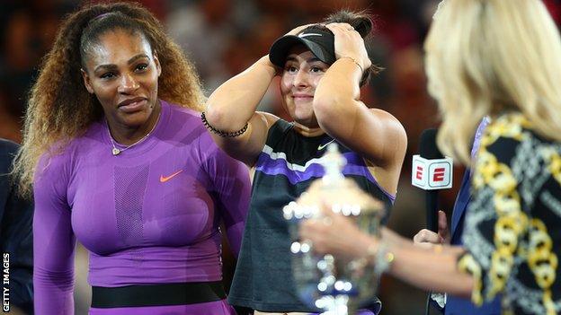 Bianca Andreescu puts her hands on her head as Tracy Austin brings the US Open trophy towards her