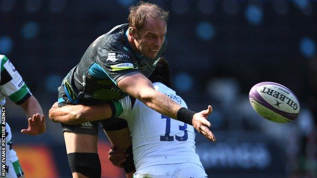 Ospreys lock Alun Wyn Jones gets the ball away under pressure from Newcastle centre Peter Lucock