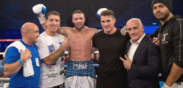 Josh Taylor, flanked by his coach from his amateur days Terry McCormack (second from left)