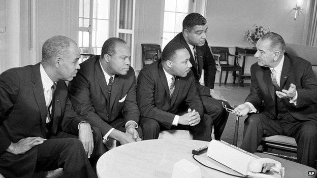 U.S. President Lyndon B. Johnson, right, talks with civil rights leaders in his White House office in Washington, D.C. in this Jan. 18, 1964 file photo.