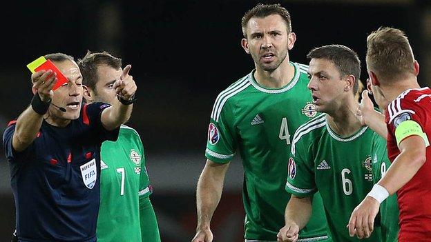 Chris Baird is left stunned as he is sent off by Turkish referee Cuneyt Cakir