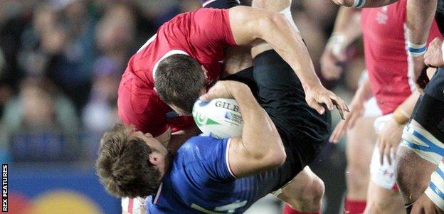 Wales skipper Sam Warburton up-ends France wing Vincent Clerc