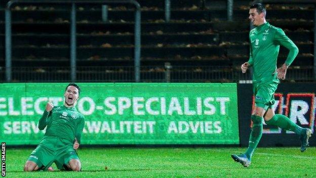 Lommel players celebrate scoring a goal