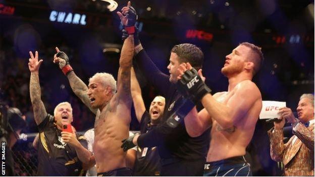 Charles Oliveira of Brazil celebrates after his submission victory over Justin Gaethje