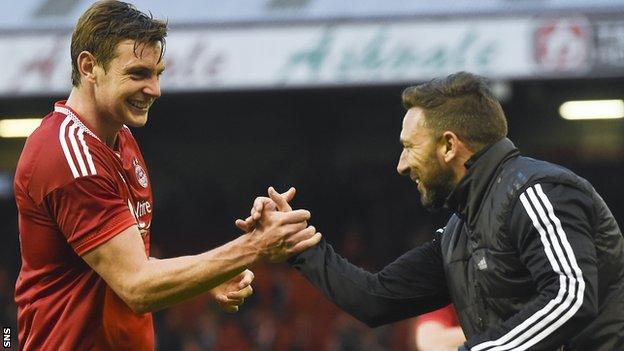 Aberdeen defender Ash Taylor and manager Derek McInnes celebrate