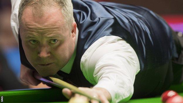 John Higgins plays a pot against Ronnie O'Sullivan