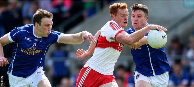 Conor McAtamney of Derry comes under pressure from Cavan's Gearoid McKiernan and Tomas Corr